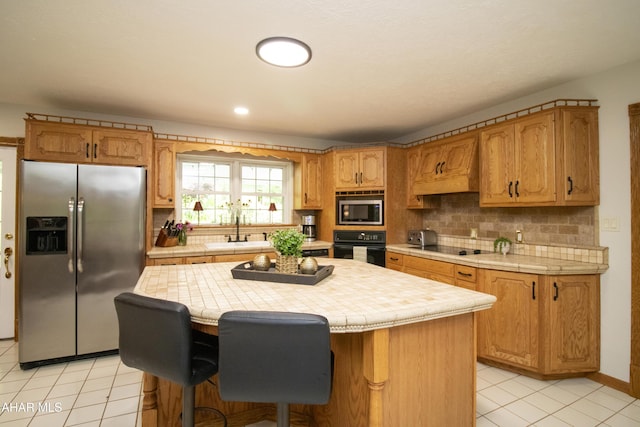 259 Chimney Rocks Rd, Hollidaysburg, PA 16648 - kitchen featuring stainless steel appliances, a sink, tile counters, light tile patterned flooring, and decorative backsplash