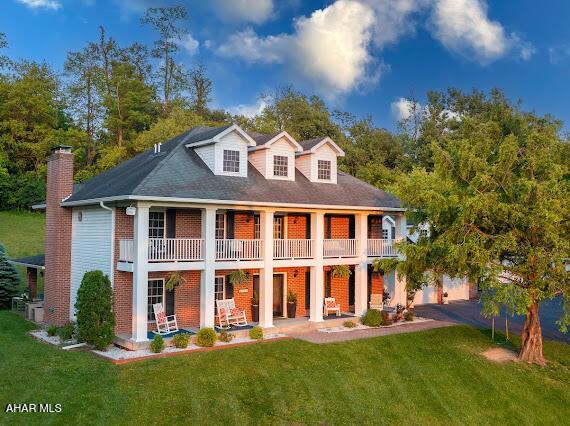 259 Chimney Rocks Rd, Hollidaysburg, PA 16648 - back of property featuring a balcony, a lawn, and a chimney