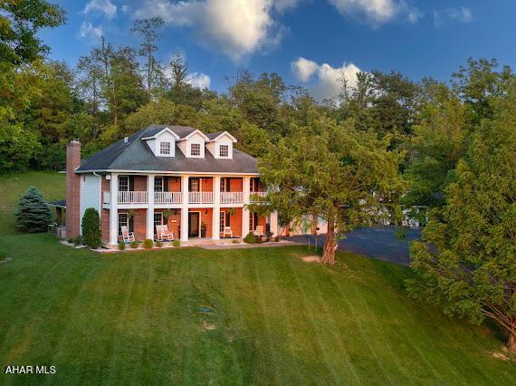 259 Chimney Rocks Rd, Hollidaysburg, PA 16648 - view of front of property with a front lawn, a chimney, a balcony, and a porch