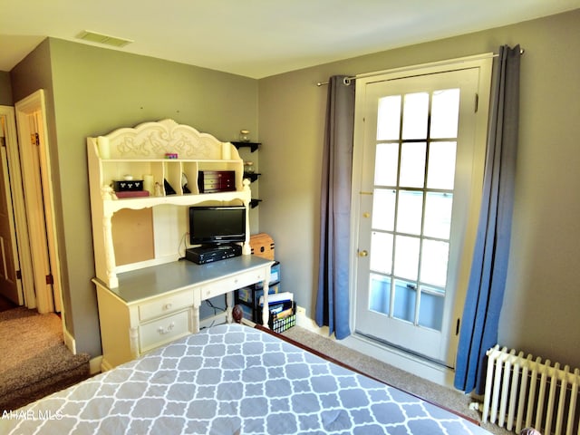 carpeted bedroom featuring radiator heating unit