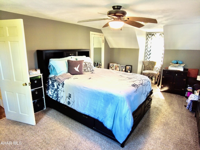 bedroom featuring ceiling fan, light carpet, and vaulted ceiling