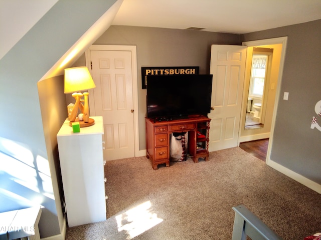 carpeted living room with lofted ceiling