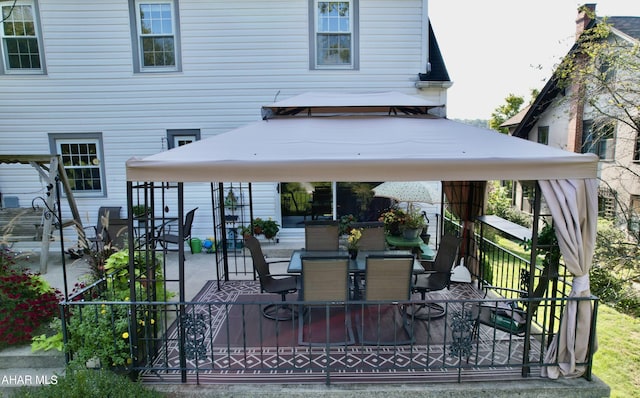 rear view of property with a gazebo