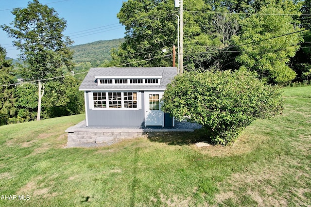 view of outdoor structure featuring a yard