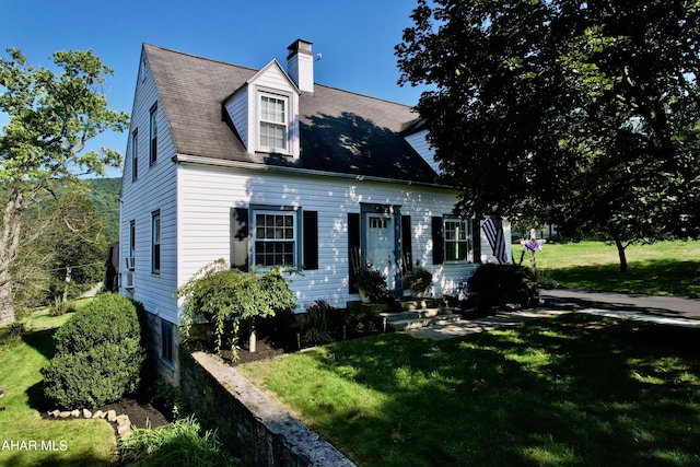 cape cod home featuring a front yard