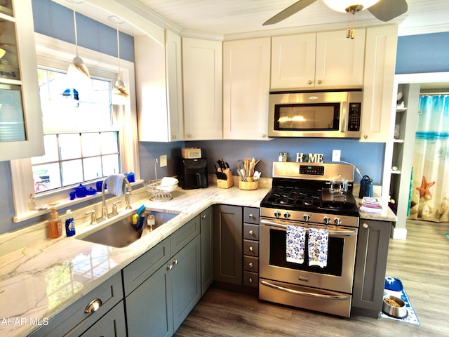 kitchen featuring appliances with stainless steel finishes, dark hardwood / wood-style flooring, gray cabinetry, sink, and white cabinets