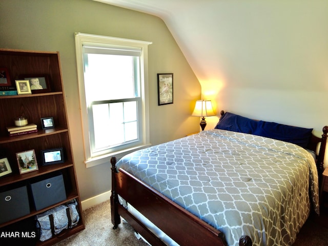 bedroom featuring carpet and vaulted ceiling