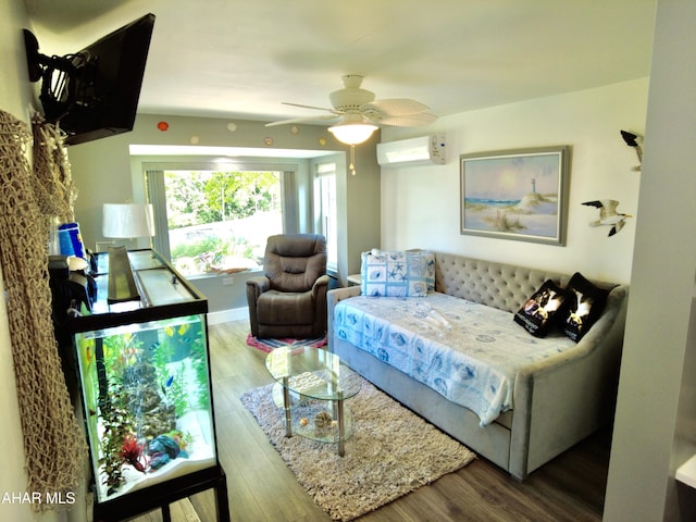 living room with a wall unit AC, ceiling fan, and wood-type flooring