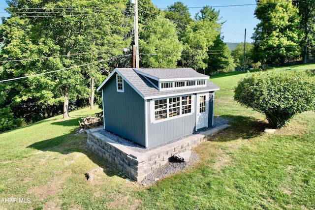 view of outbuilding featuring a lawn