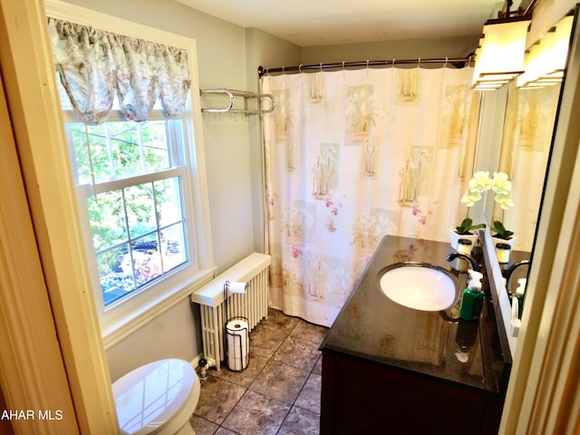 bathroom featuring radiator, tile patterned flooring, vanity, and toilet