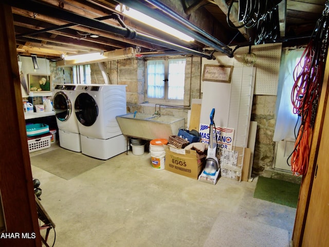 basement with sink and washer and dryer