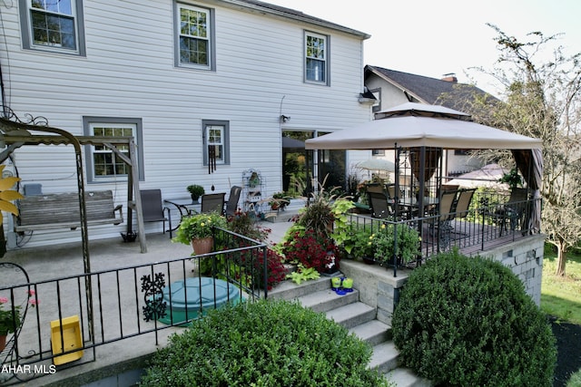 back of house with a gazebo and a patio area