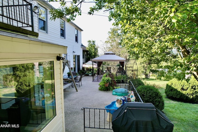 view of patio / terrace featuring a gazebo and a grill