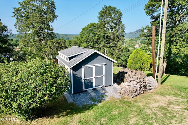 view of outbuilding with a yard