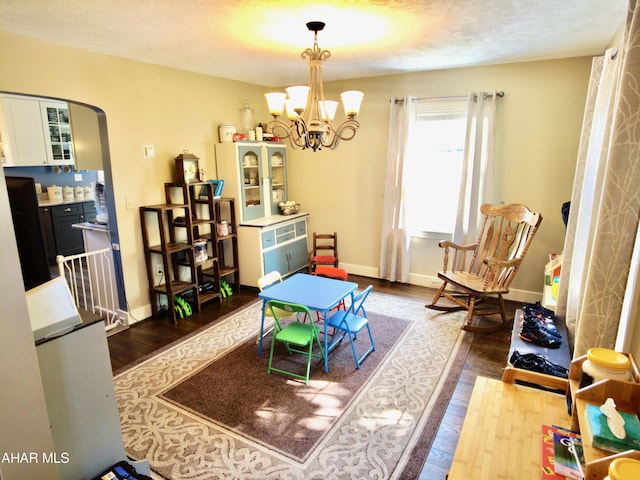 playroom with hardwood / wood-style floors, a textured ceiling, and an inviting chandelier