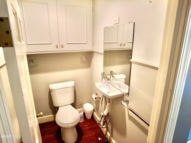 bathroom with sink, wood-type flooring, and toilet