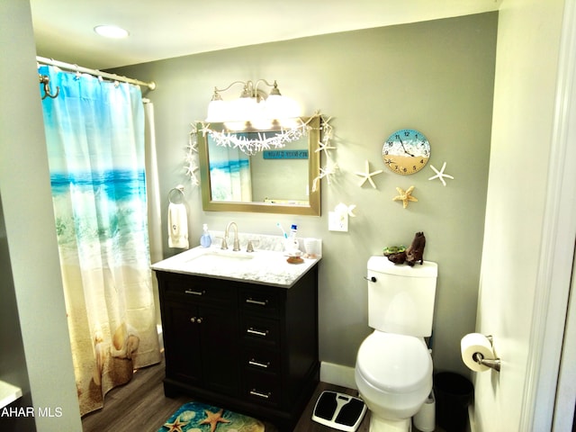 bathroom with vanity, hardwood / wood-style flooring, and toilet