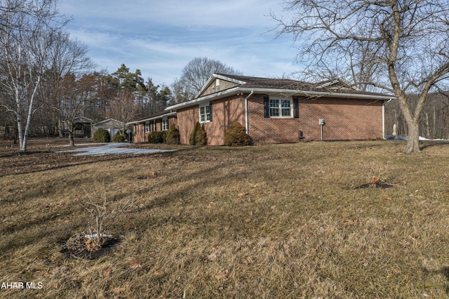 view of home's exterior with a lawn and brick siding