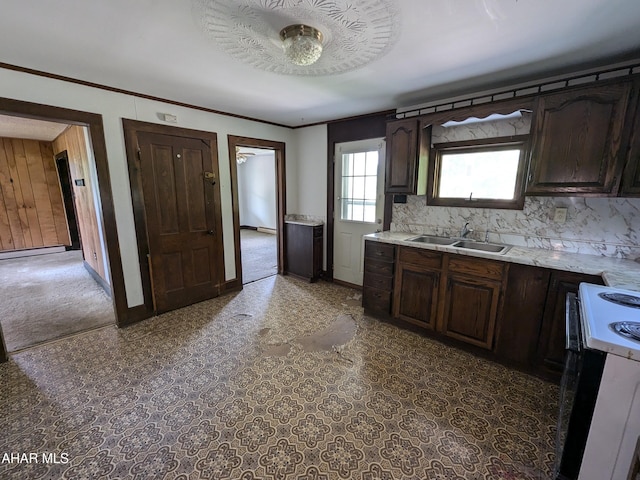 kitchen with white electric range oven, dark brown cabinets, decorative backsplash, and sink