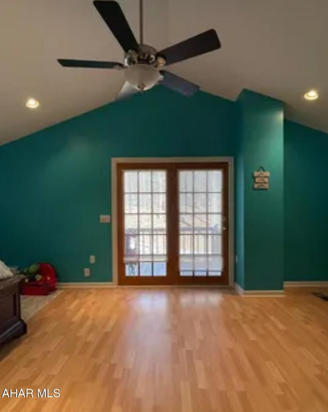 interior space featuring vaulted ceiling, light wood finished floors, a ceiling fan, baseboards, and recessed lighting