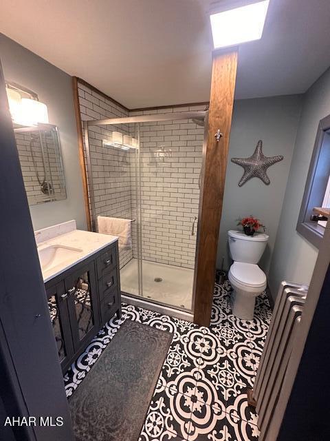 193 Pavia Rd, Imler, PA 16655 - bathroom featuring vanity, toilet, a shower stall, and tile patterned flooring