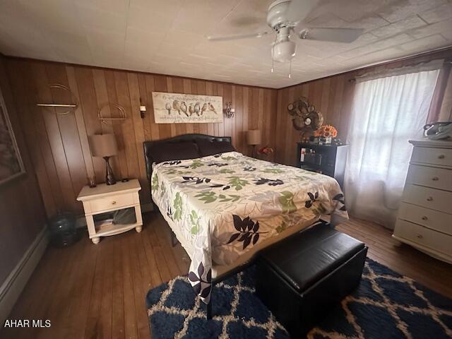 193 Pavia Rd, Imler, PA 16655 - bedroom with wood-type flooring, wooden walls, and a ceiling fan