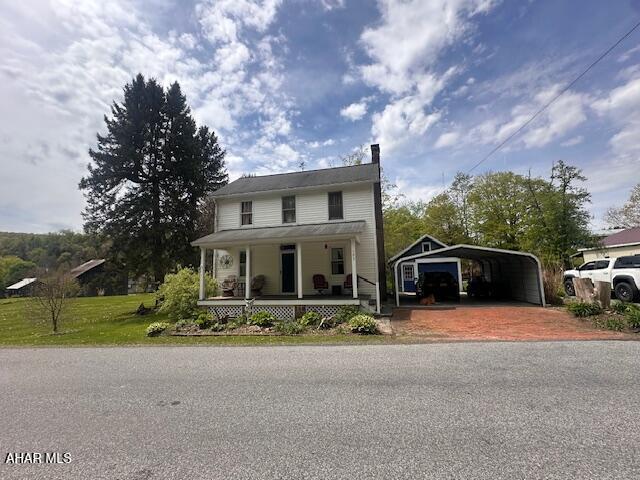 193 Pavia Rd, Imler, PA 16655 - farmhouse with a porch, a detached carport, a chimney, and driveway