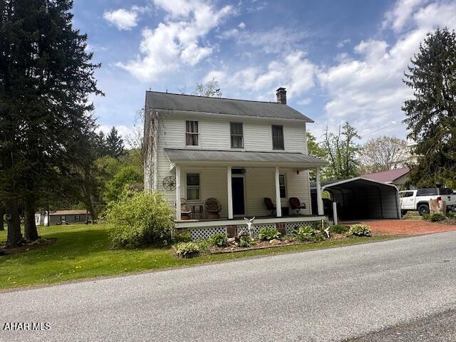 193 Pavia Rd, Imler, PA 16655 - farmhouse inspired home with a carport, a porch, a chimney, and a front yard
