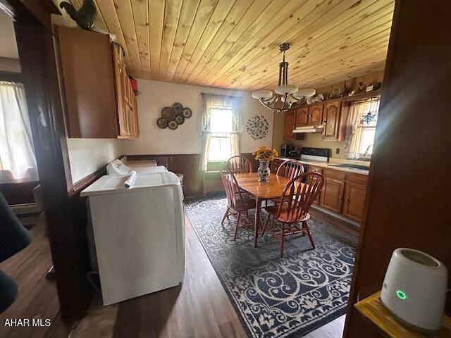 193 Pavia Rd, Imler, PA 16655 - dining area with wooden ceiling, washing machine and clothes dryer, a chandelier, dark wood-style floors, and a wainscoted wall