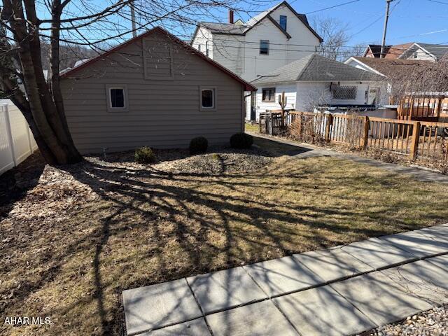 rear view of house featuring fence