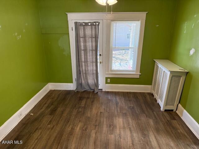 entryway featuring baseboards and wood finished floors