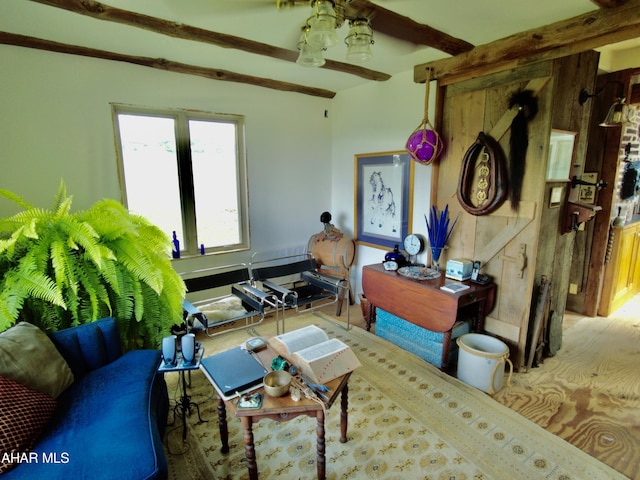 living room with beam ceiling and wooden walls