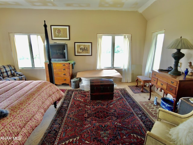 carpeted bedroom with vaulted ceiling