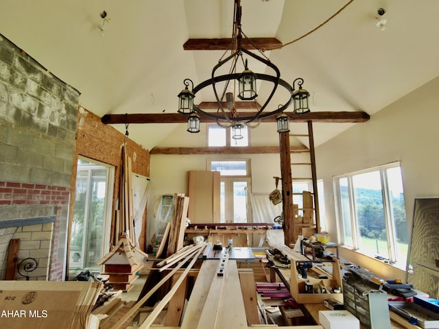 miscellaneous room featuring a healthy amount of sunlight and high vaulted ceiling