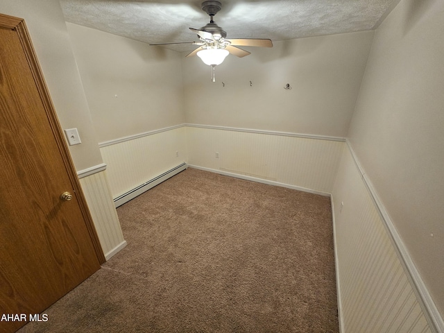 carpeted spare room with ceiling fan, a baseboard radiator, and a textured ceiling