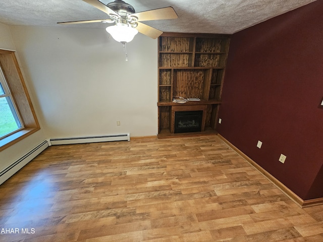 unfurnished living room featuring light wood-type flooring, a textured ceiling, baseboard heating, and ceiling fan