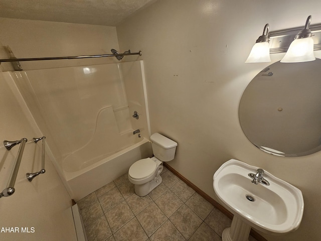 full bathroom with sink, tile patterned floors, a textured ceiling, toilet, and shower / tub combination