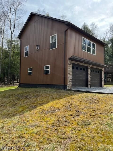 view of home's exterior featuring a garage and a lawn