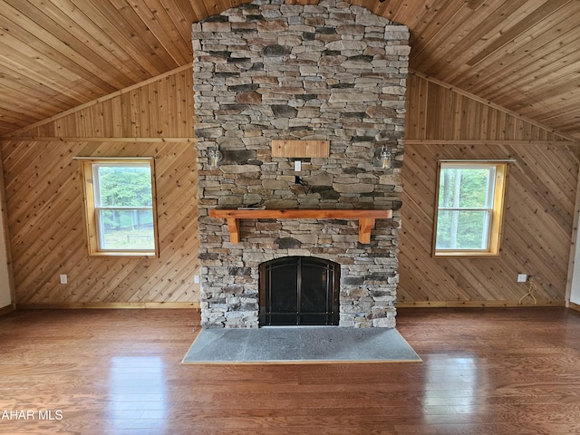 unfurnished living room featuring plenty of natural light, wood walls, and wood ceiling