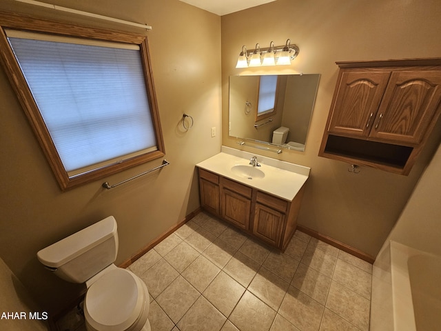 bathroom featuring tile patterned floors, vanity, and toilet