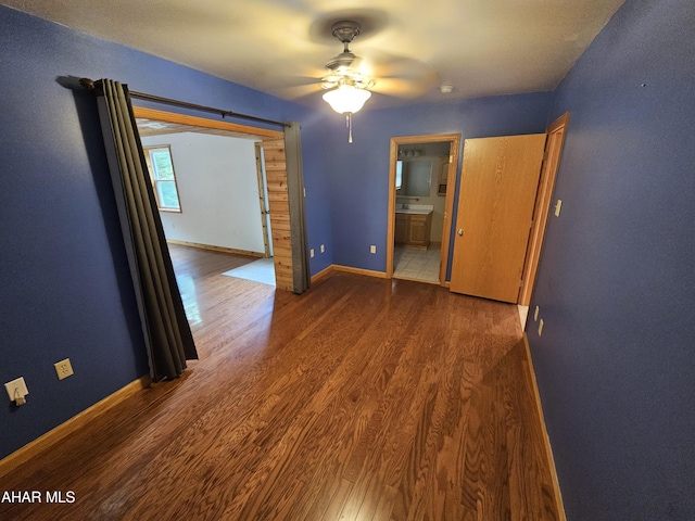 spare room featuring ceiling fan and dark wood-type flooring