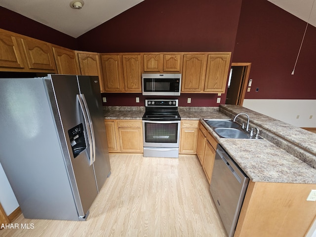 kitchen with light hardwood / wood-style floors, sink, stainless steel appliances, and high vaulted ceiling