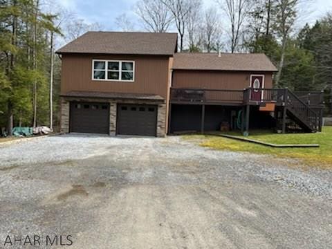 view of front of house featuring a garage and a deck