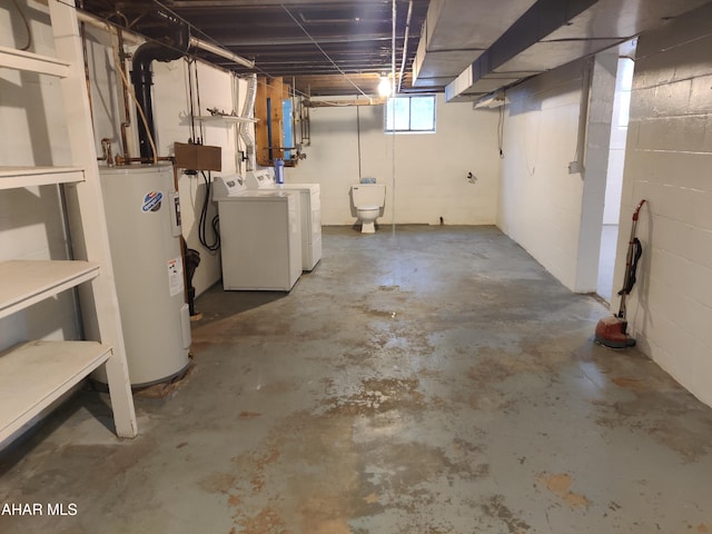 basement featuring washing machine and clothes dryer and water heater