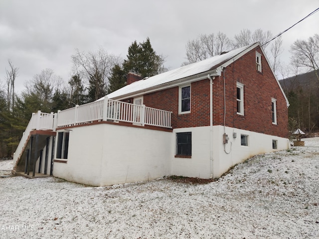 view of home's exterior with a wooden deck