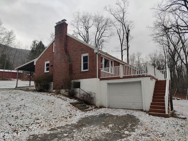 view of snow covered exterior featuring a carport