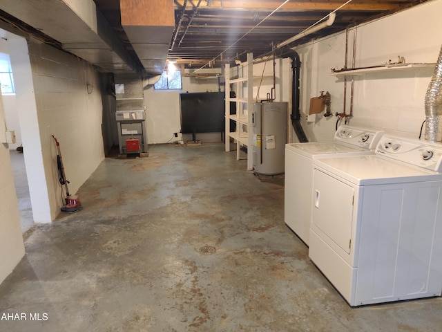 basement featuring washer and dryer, electric water heater, and heating unit