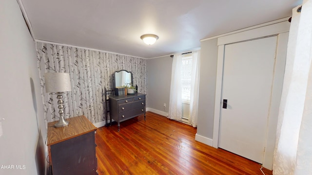 bedroom with baseboards and wood finished floors