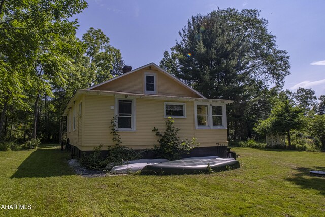 143 Rider Farm Rd, Altoona, PA 16601 - back of house featuring a yard and a chimney