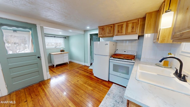 143 Rider Farm Rd, Altoona, PA 16601 - kitchen featuring white appliances, light wood-style flooring, light countertops, backsplash, and under cabinet range hood